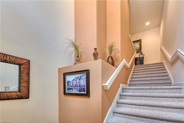 a view of staircase with furniture and stairs