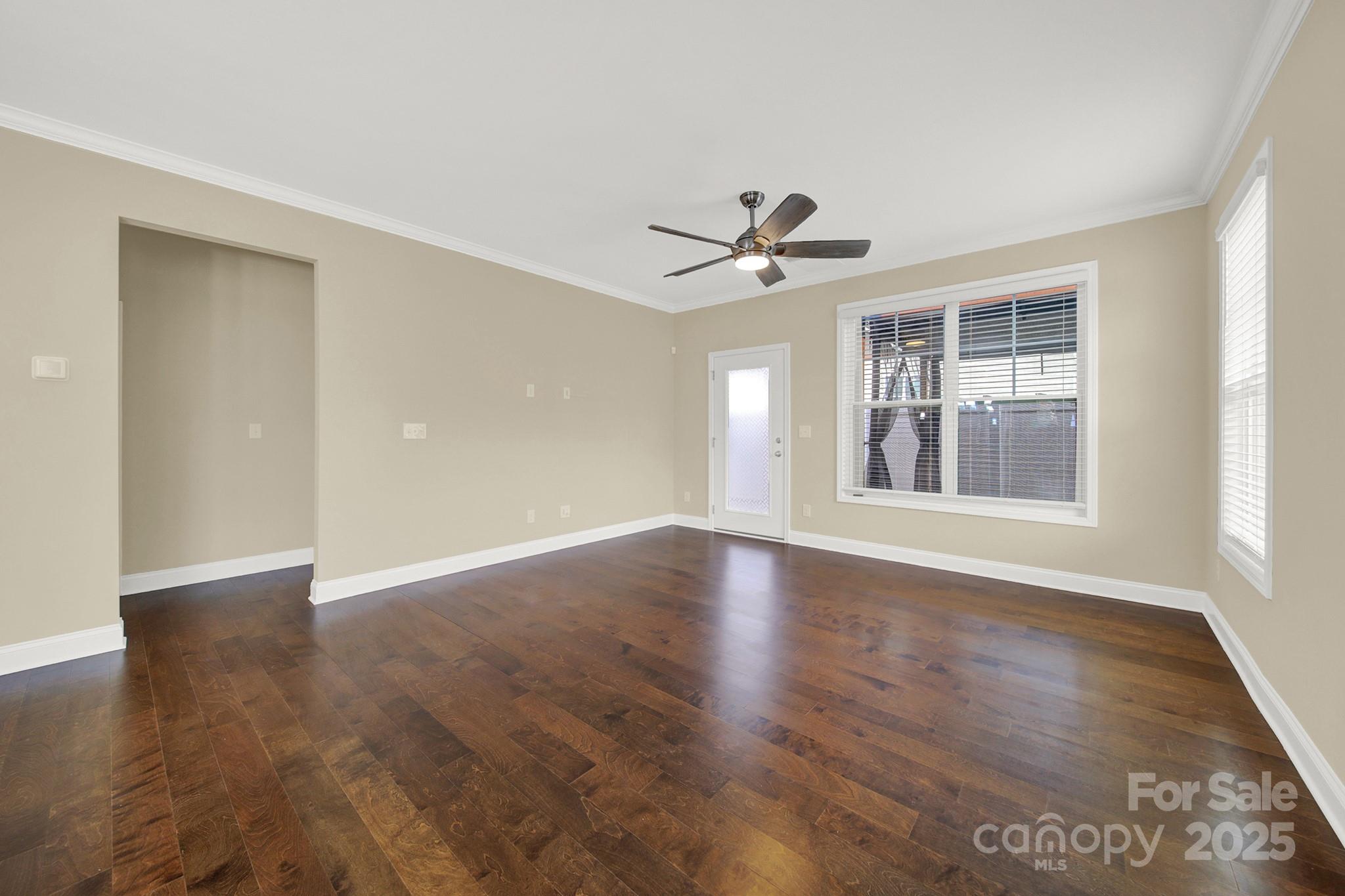 2471 Palmdale Walk Drive, Unit 107 Fort Mill, SC 29708 - Photo 11 of 30 a view of wooden floor and a chandelier fan in a room