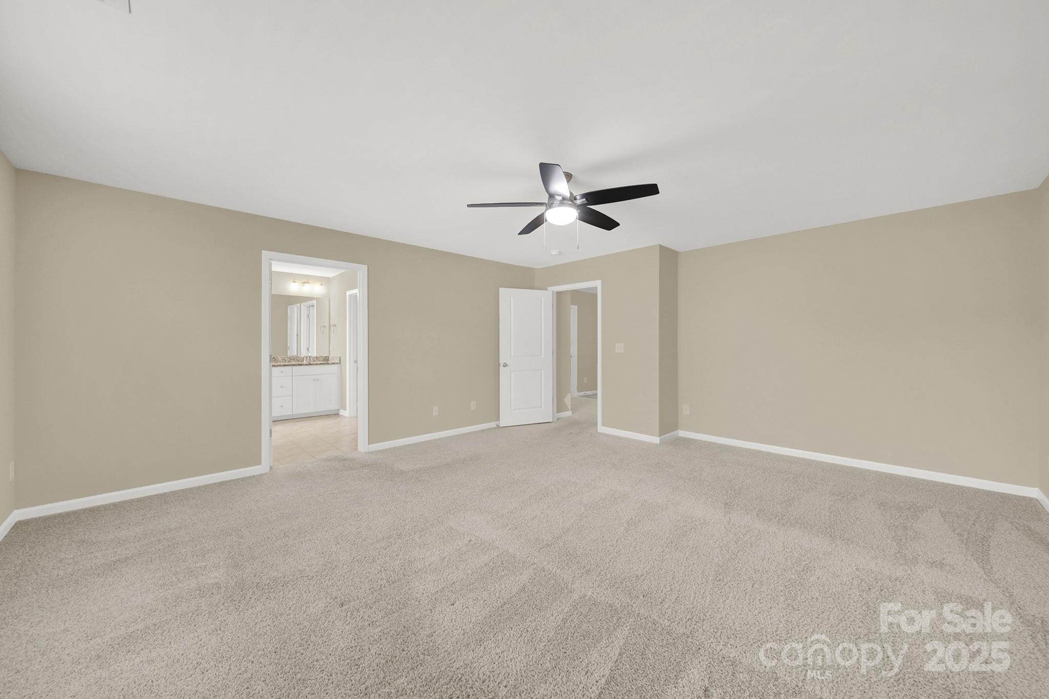 2471 Palmdale Walk Drive, Unit 107 Fort Mill, SC 29708 - Photo 15 of 30 a view of an empty room with a ceiling fan