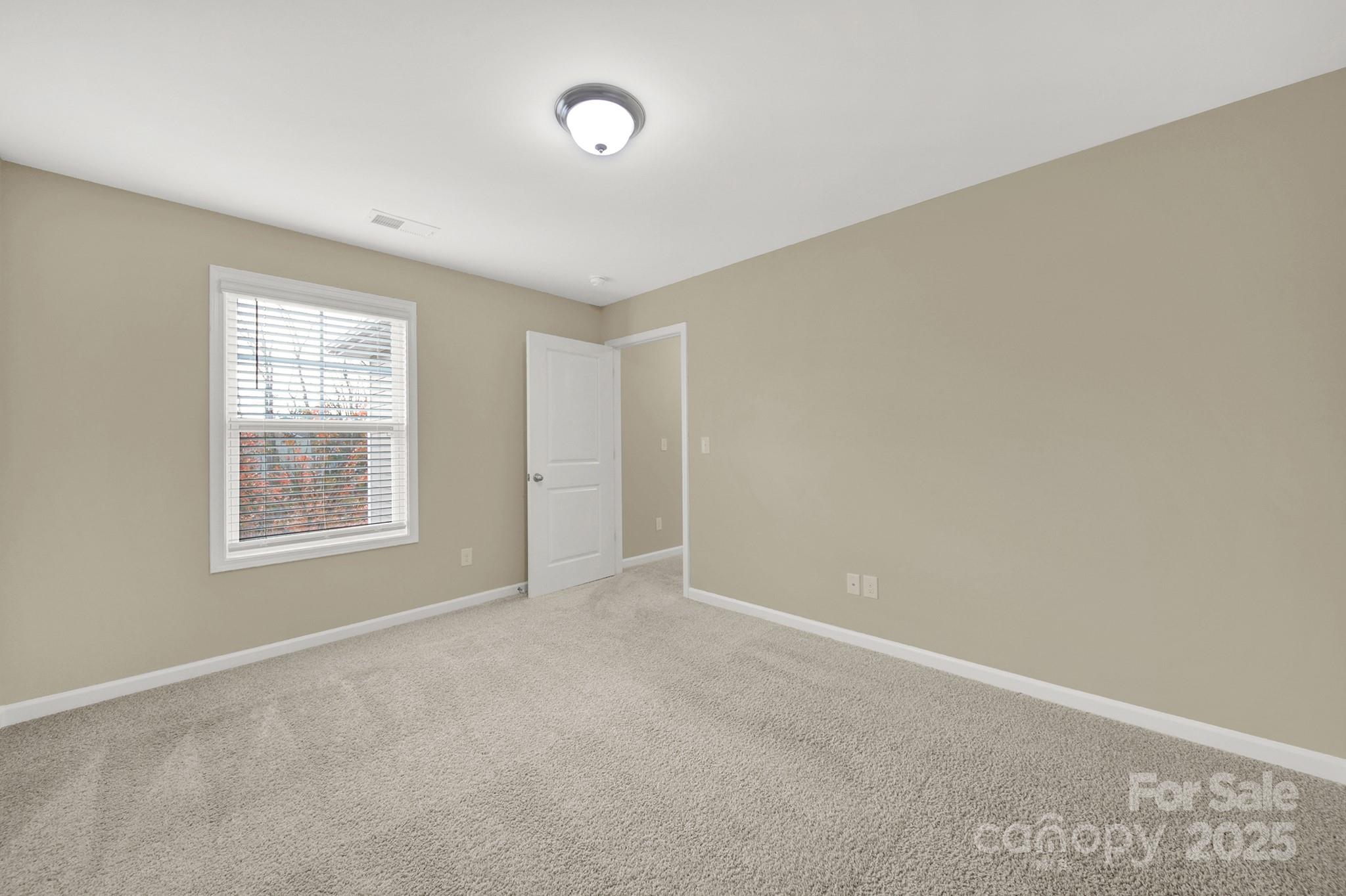 2471 Palmdale Walk Drive, Unit 107 Fort Mill, SC 29708 - Photo 23 of 30 an empty room with windows