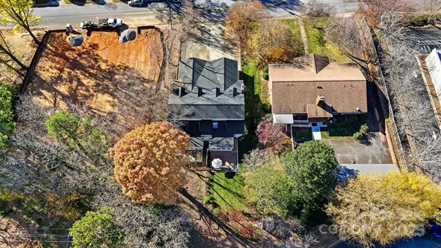an aerial view of residential houses with city view