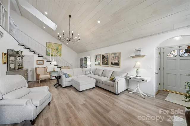 a living room with furniture fireplace and a chandelier