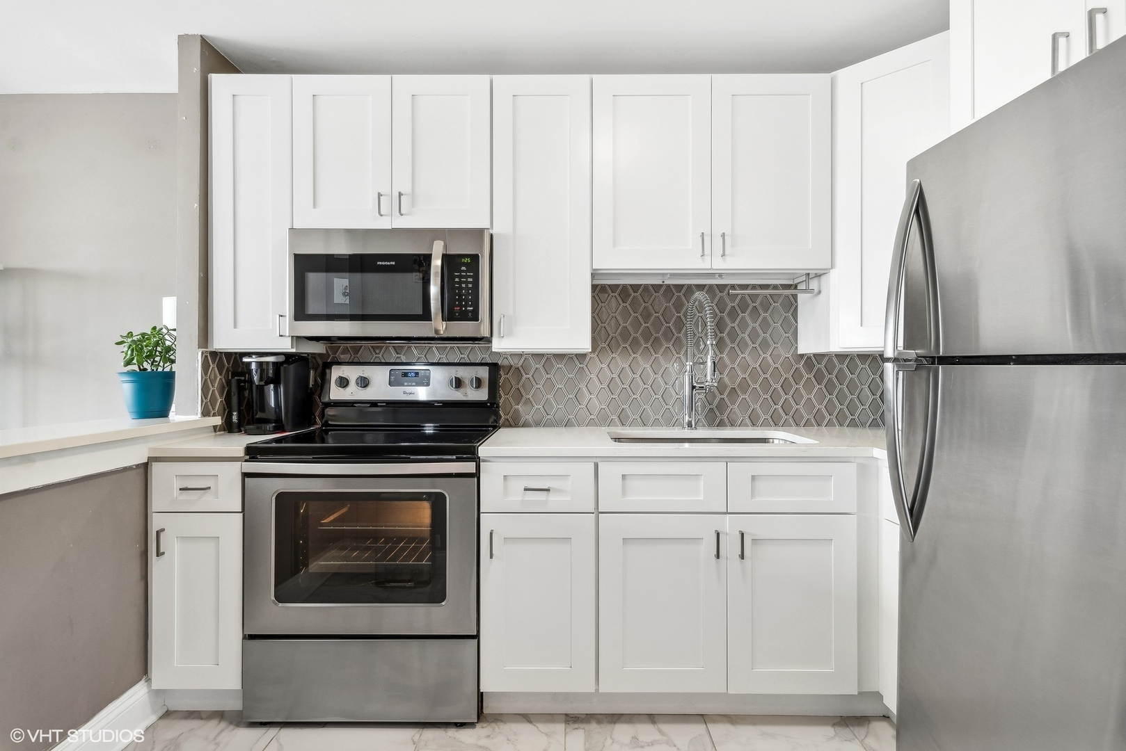 5445 North Sheridan Road, Unit 1905 Chicago, IL 60640 - Photo 4 of 10 a kitchen with cabinets stainless steel appliances and a counter space