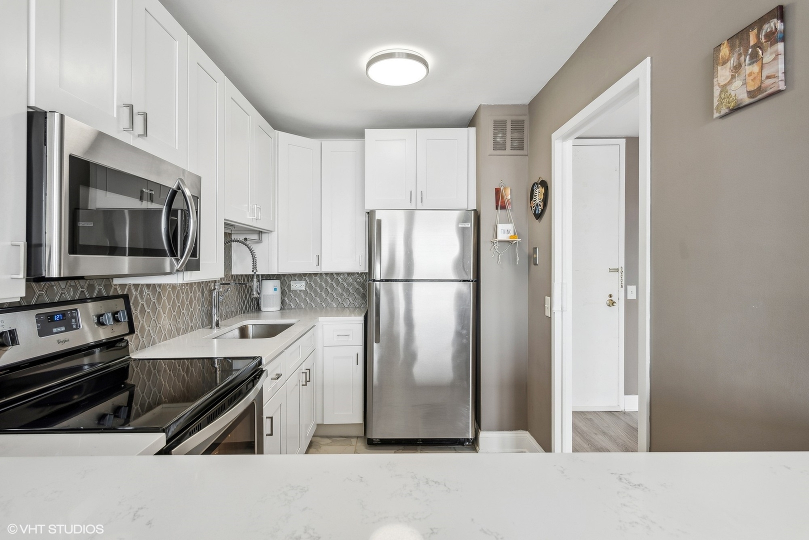5445 North Sheridan Road, Unit 1905 Chicago, IL 60640 - Photo 5 of 10 a kitchen with stainless steel appliances a refrigerator stove microwave and sink