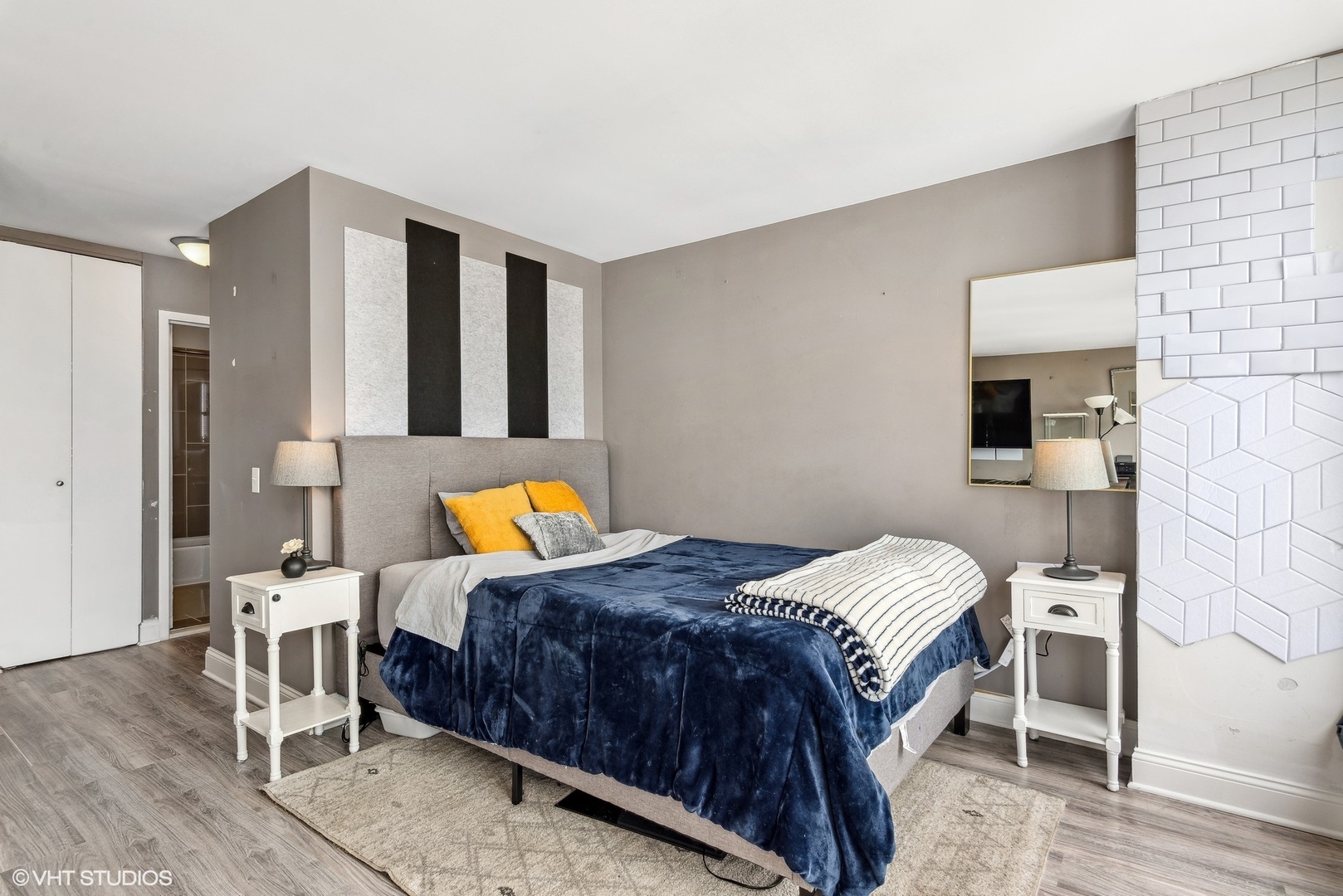 5445 North Sheridan Road, Unit 1905 Chicago, IL 60640 - Photo 8 of 10 a bedroom with a bed and a chair