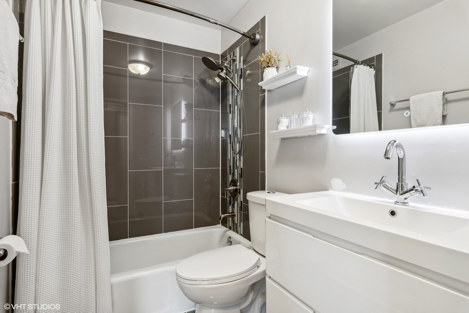 5445 North Sheridan Road, Unit 1905 Chicago, IL 60640 - Photo 9 of 10 a bathroom with a sink toilet and shower