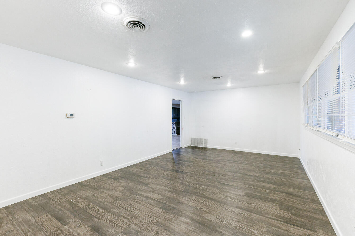 3515 36th Street Lubbock, TX 79413 - Photo 11 of 63 an empty room with wooden floor and windows