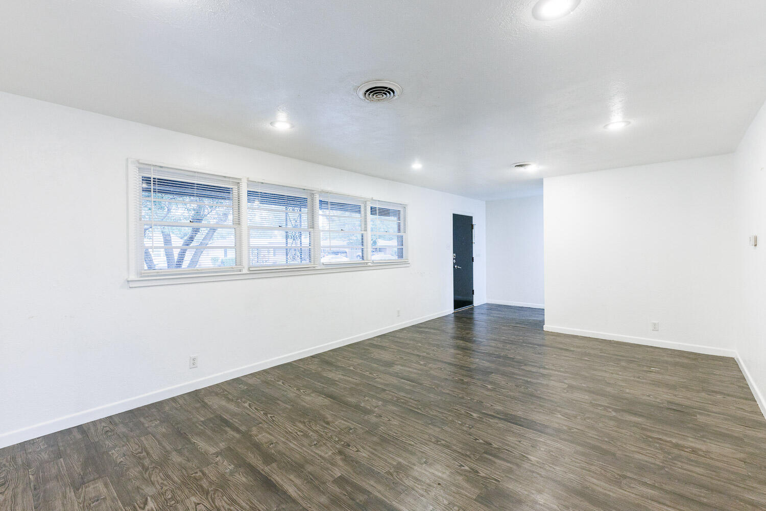 3515 36th Street Lubbock, TX 79413 - Photo 12 of 63 an empty room with wooden floor and windows