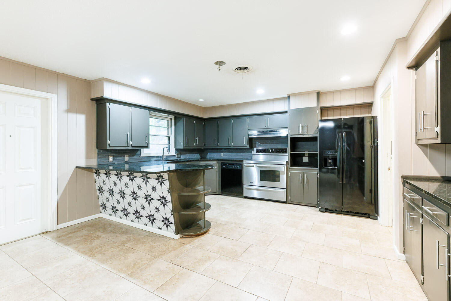 3515 36th Street Lubbock, TX 79413 - Photo 19 of 63 a kitchen with stainless steel appliances granite countertop a refrigerator and a stove