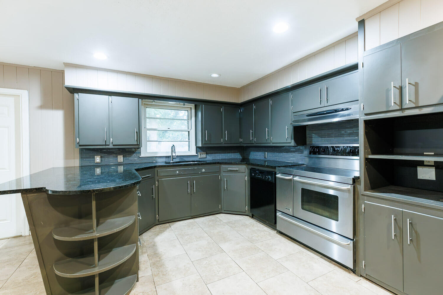 3515 36th Street Lubbock, TX 79413 - Photo 25 of 63 a kitchen with stainless steel appliances granite countertop a stove a sink and a microwave
