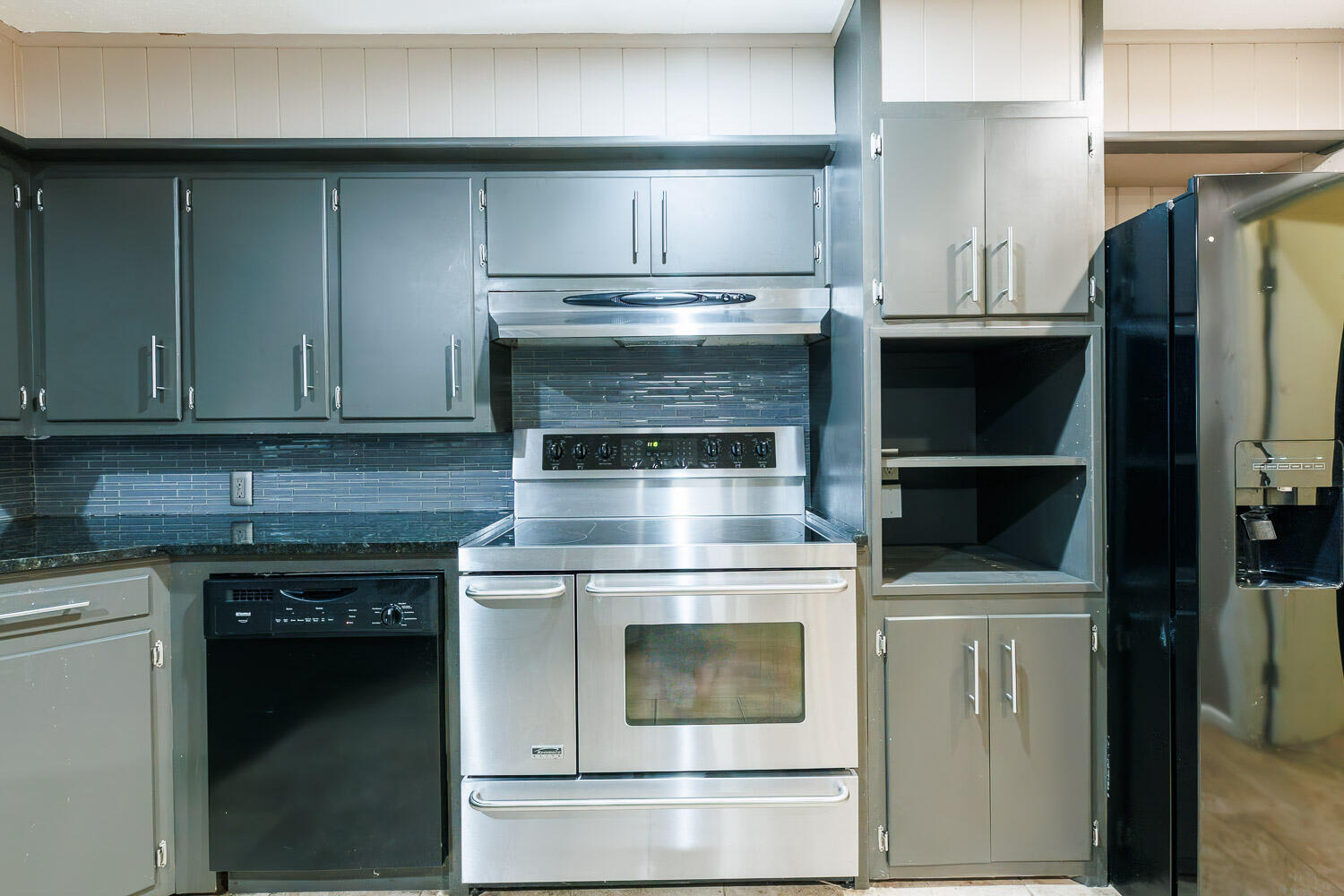 3515 36th Street Lubbock, TX 79413 - Photo 26 of 63 a kitchen with granite countertop a stove and a refrigerator