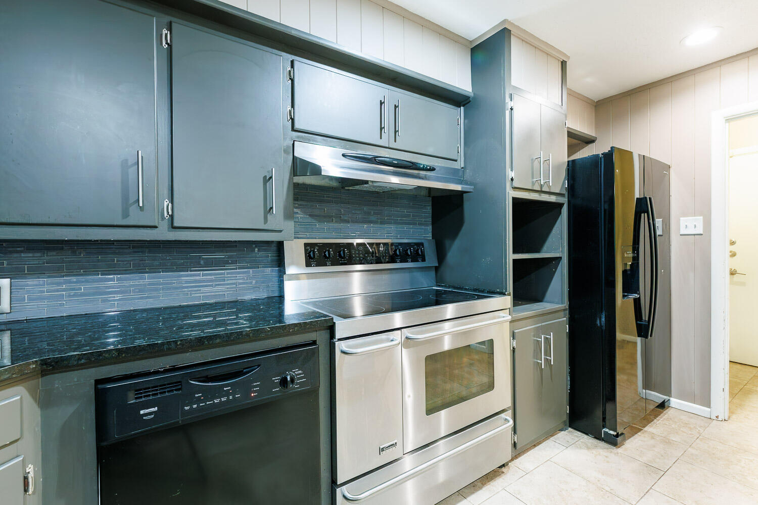 3515 36th Street Lubbock, TX 79413 - Photo 27 of 63 a kitchen with stainless steel appliances granite countertop a stove and a refrigerator