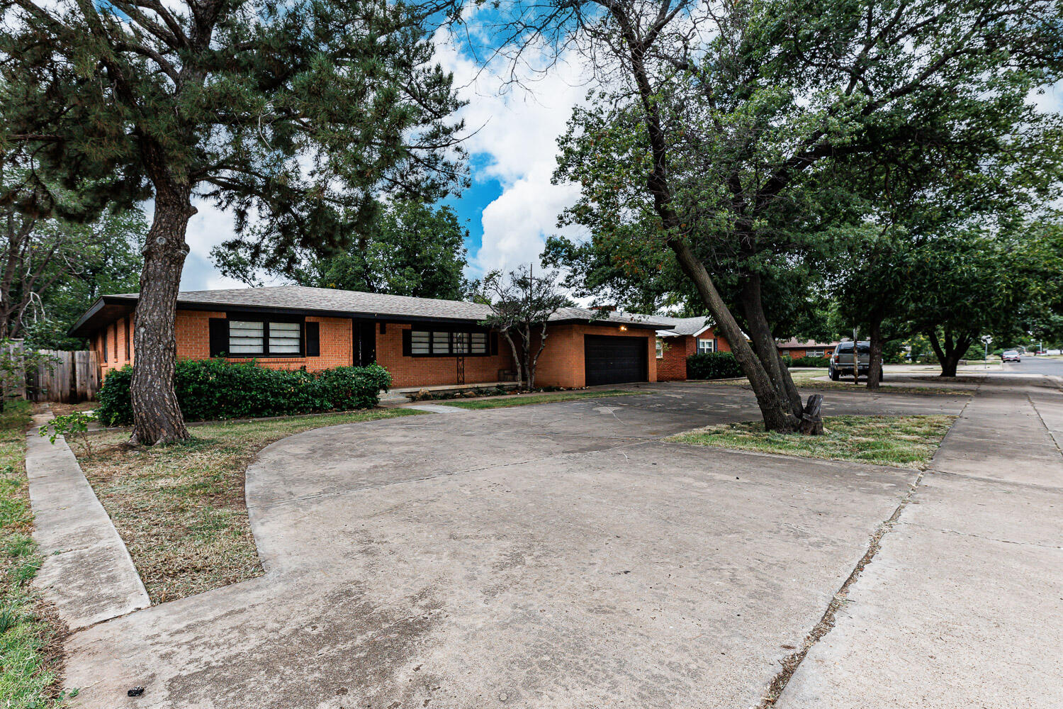 3515 36th Street Lubbock, TX 79413 - Photo 3 of 63 a front view of a house with a yard and trees