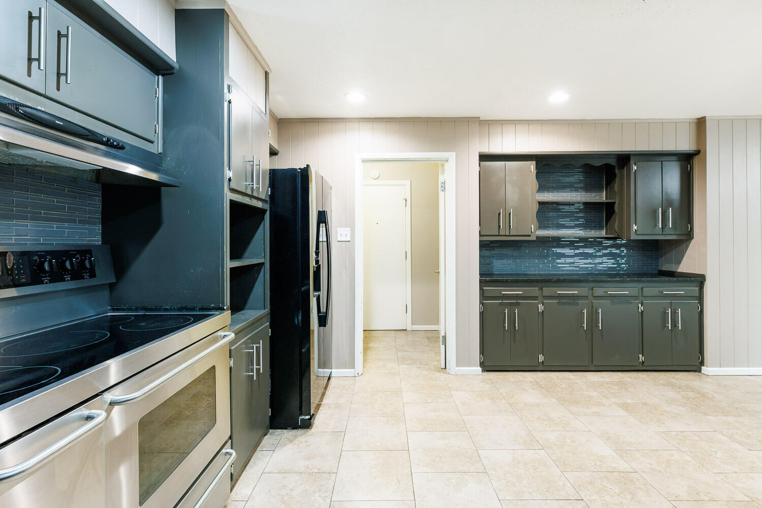 3515 36th Street Lubbock, TX 79413 - Photo 32 of 63 a kitchen with stainless steel appliances granite countertop a refrigerator and a stove top oven
