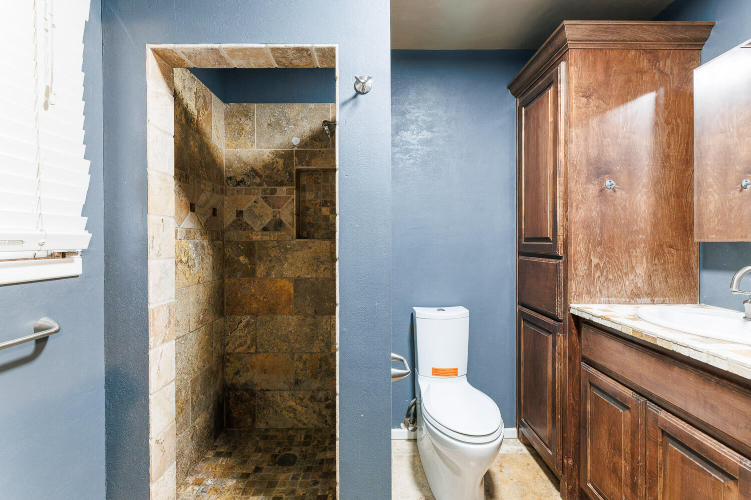 3515 36th Street Lubbock, TX 79413 - Photo 39 of 63 a bathroom with a granite countertop toilet and a shower