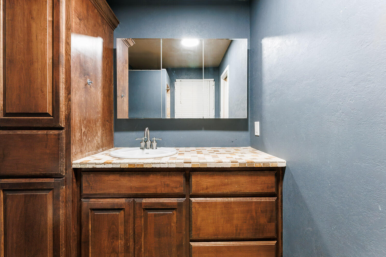 3515 36th Street Lubbock, TX 79413 - Photo 41 of 63 a bathroom with a granite countertop sink and a mirror