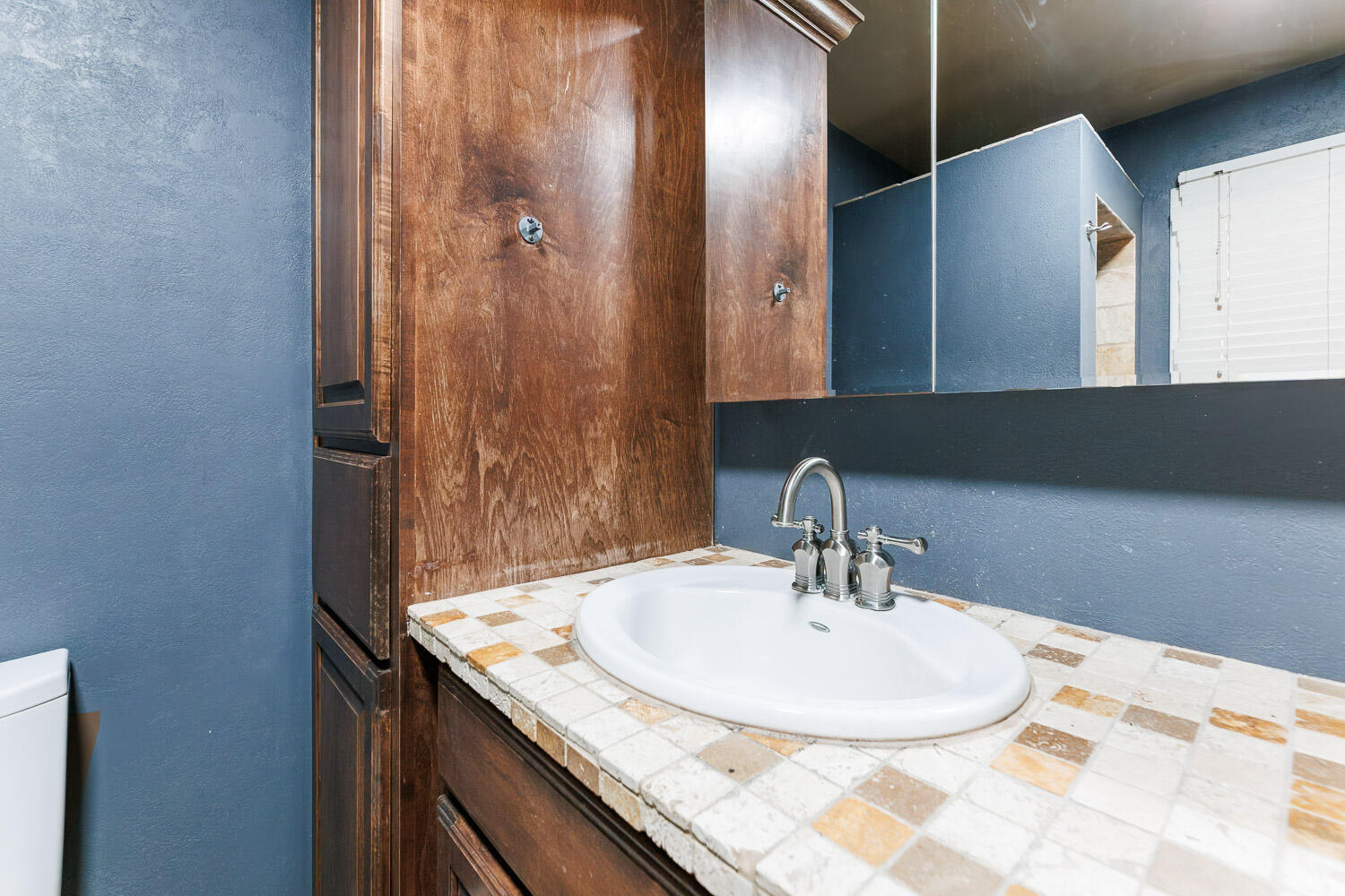 3515 36th Street Lubbock, TX 79413 - Photo 42 of 63 a bathroom with a sink and a mirror