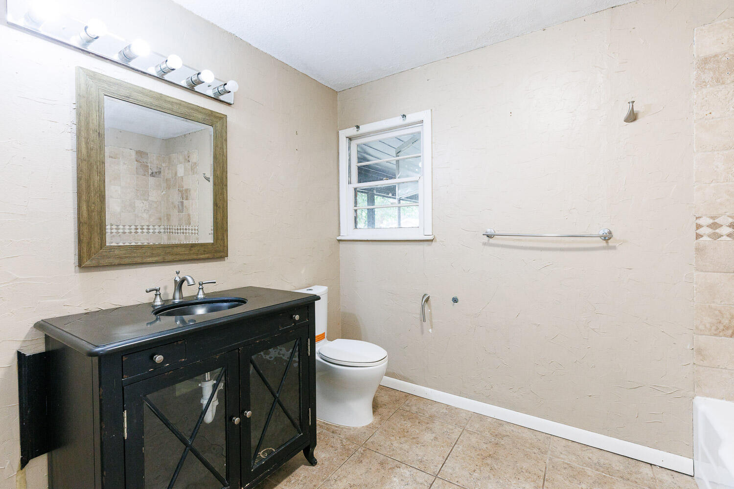3515 36th Street Lubbock, TX 79413 - Photo 50 of 63 a bathroom with a sink and a mirror