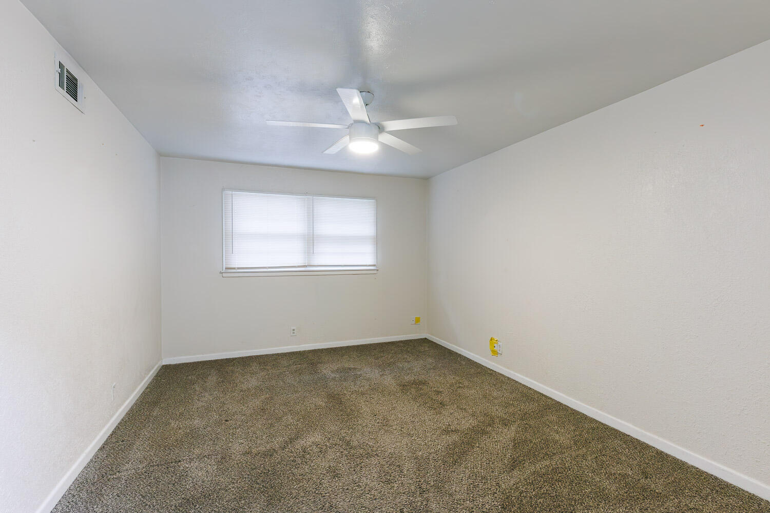 3515 36th Street Lubbock, TX 79413 - Photo 56 of 63 an empty room with a window and ceiling fan