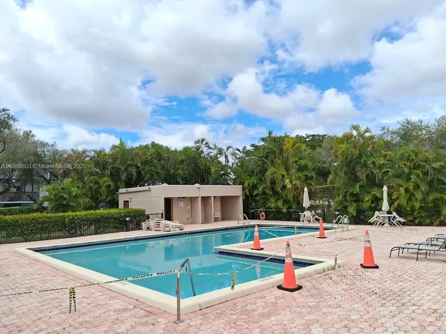 a view of a house with swimming pool and a yard
