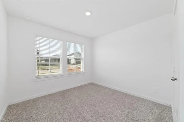 a bathroom with a granite countertop sink a toilet and a mirror