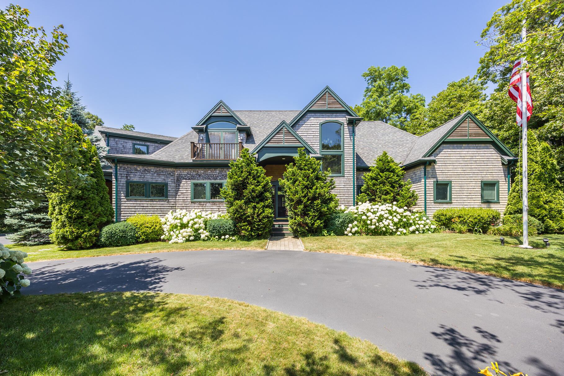 234 Cairn Ridge Road East Falmouth, MA 02536 - Photo 2 of 41 a front view of a house with a yard and potted plants