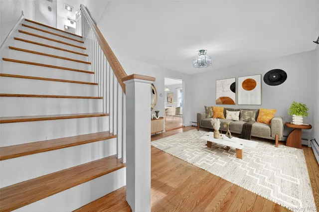 a living room with furniture cabinets and wooden floor