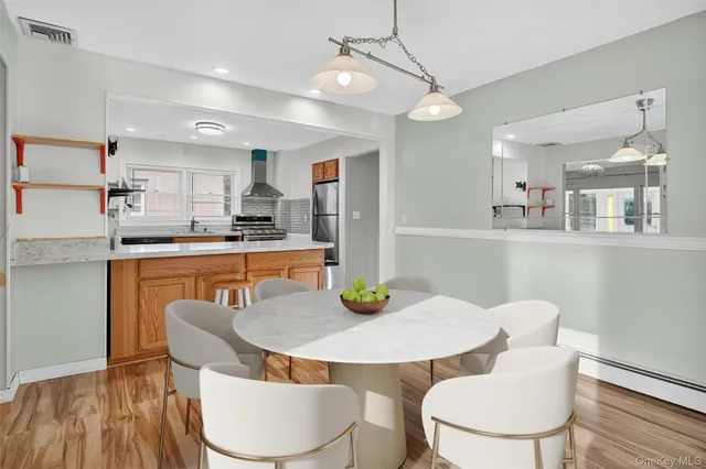 a view of a dining room with furniture and wooden floor