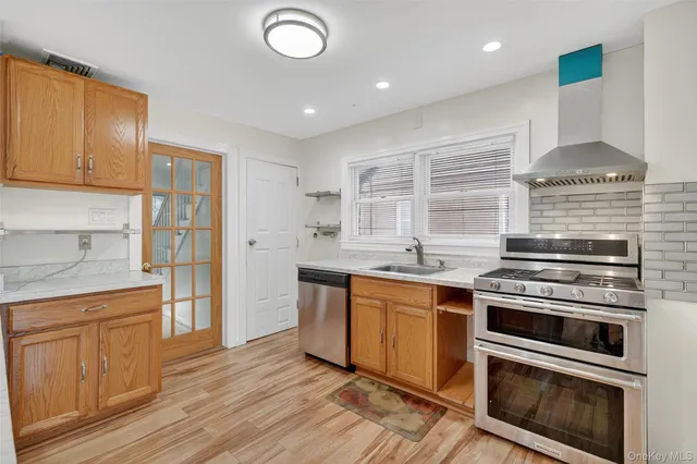 a kitchen with stainless steel appliances granite countertop a stove and a sink