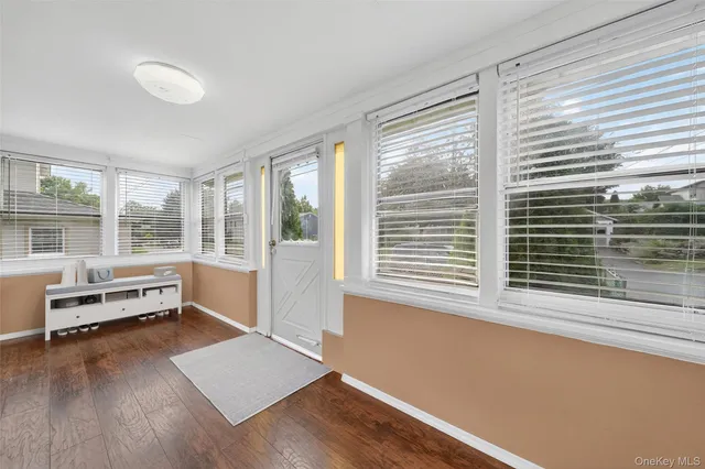 a view of a room with wooden floor and a window