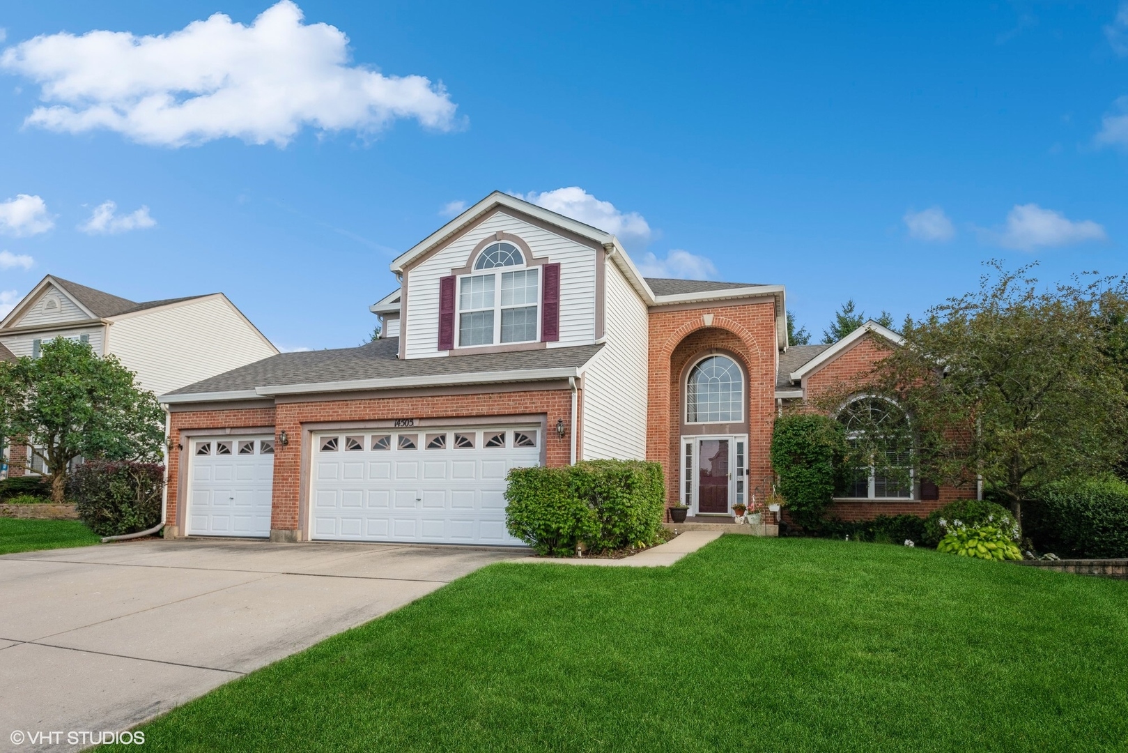 a front view of a house with a yard and garage