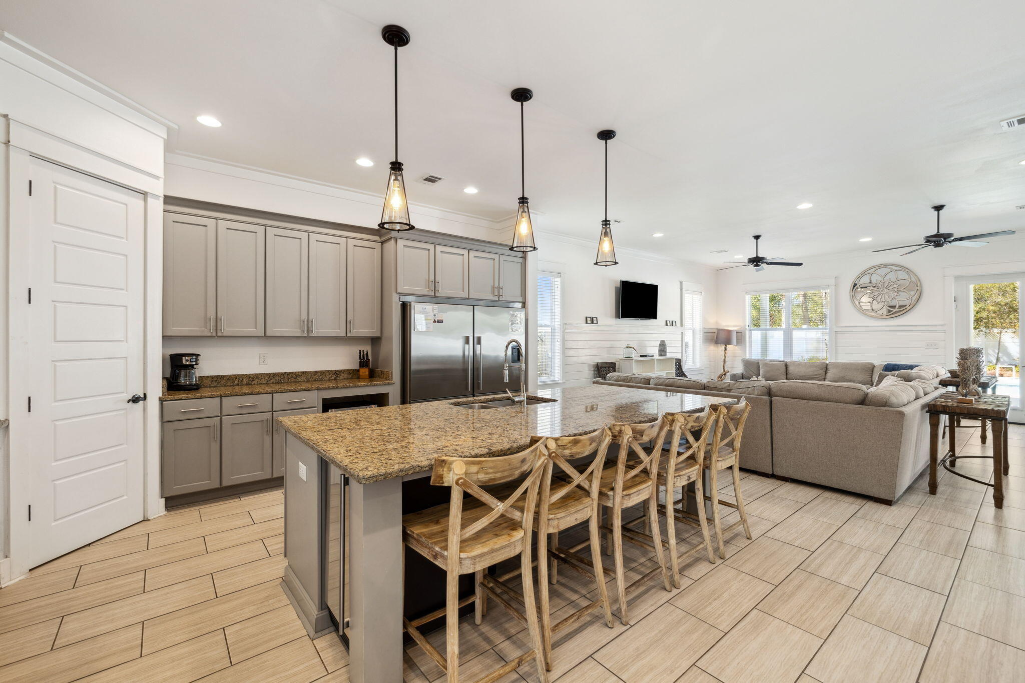85 Santa Clara Street Santa Rosa Beach, FL 32459 - Photo 12 of 54 a kitchen with stainless steel appliances kitchen island granite countertop a dining table chairs and white cabinets