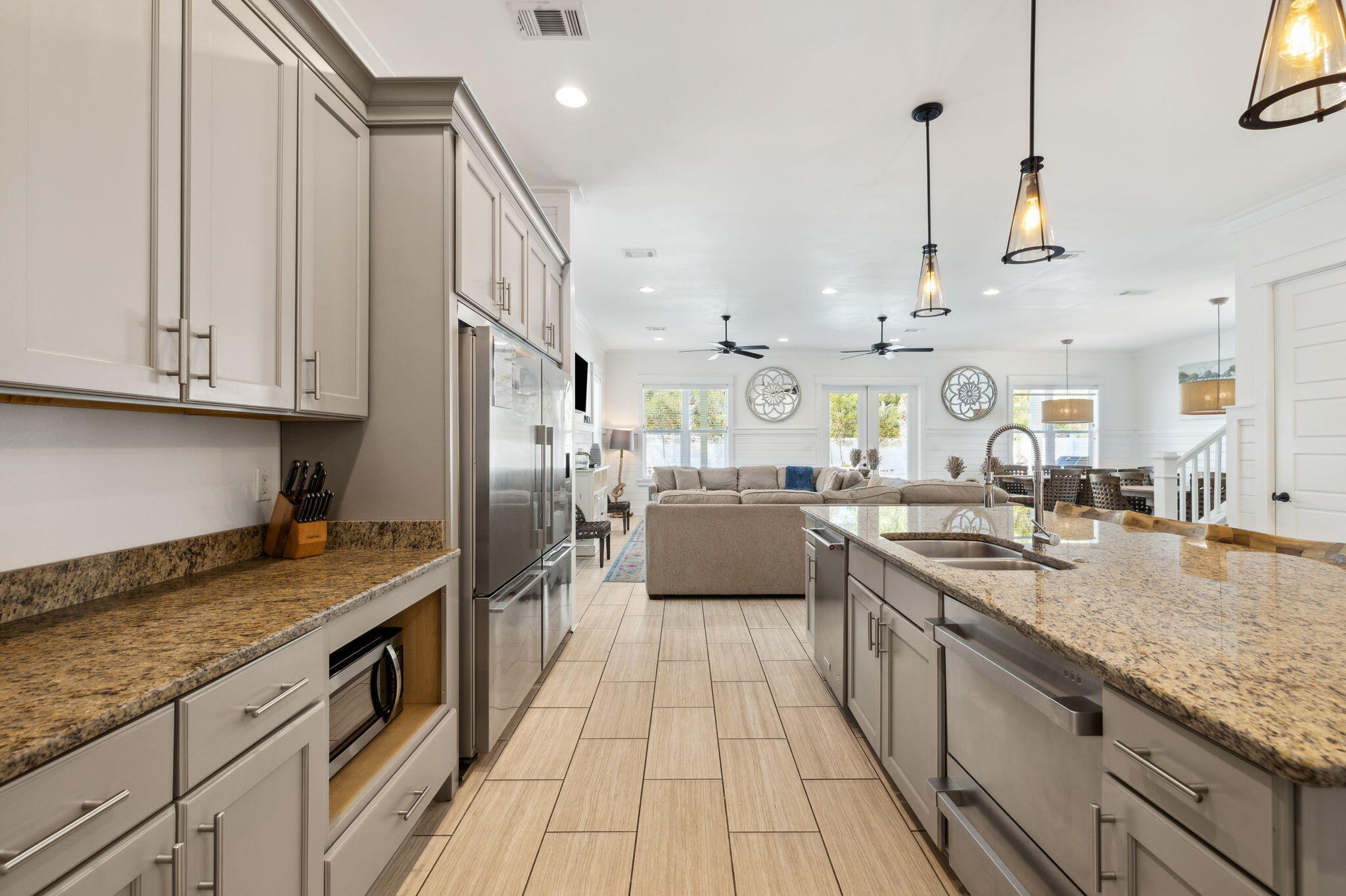 85 Santa Clara Street Santa Rosa Beach, FL 32459 - Photo 14 of 54 a kitchen with stainless steel appliances granite countertop a sink a stove and a wooden cabinets