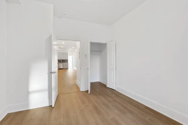 a view of hallway with wooden floor