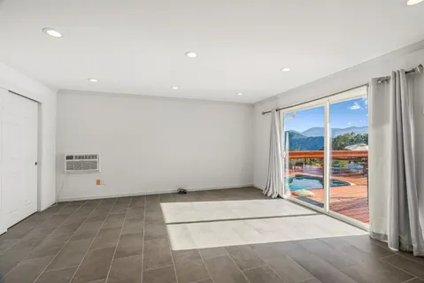 a view of a balcony with chair and a floor to ceiling window
