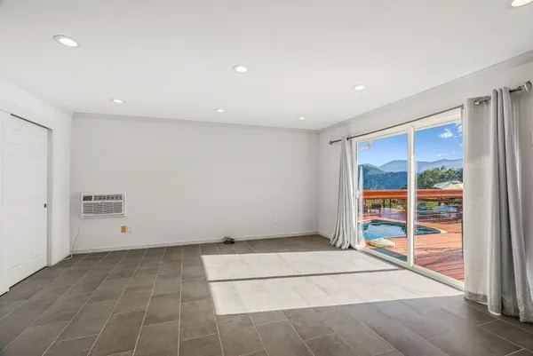 a view of a balcony with chair and a floor to ceiling window