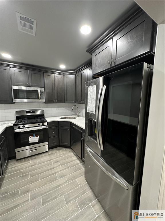 3303 Hana Road Edison, NJ 08817 - Photo 10 of 47 a kitchen with granite countertop stainless steel appliances and refrigerator