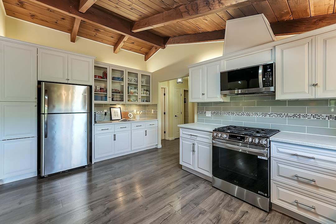 14136 Long Ridge Road Los Gatos, CA 95033 - Photo 11 of 75 a kitchen with stainless steel appliances granite countertop a stove top oven a refrigerator and a microwave