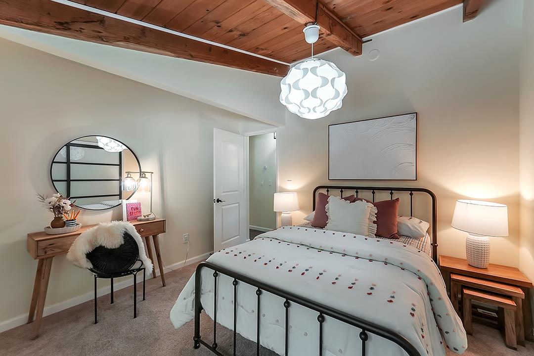 14136 Long Ridge Road Los Gatos, CA 95033 - Photo 18 of 75 a bedroom with a bed and a chandelier