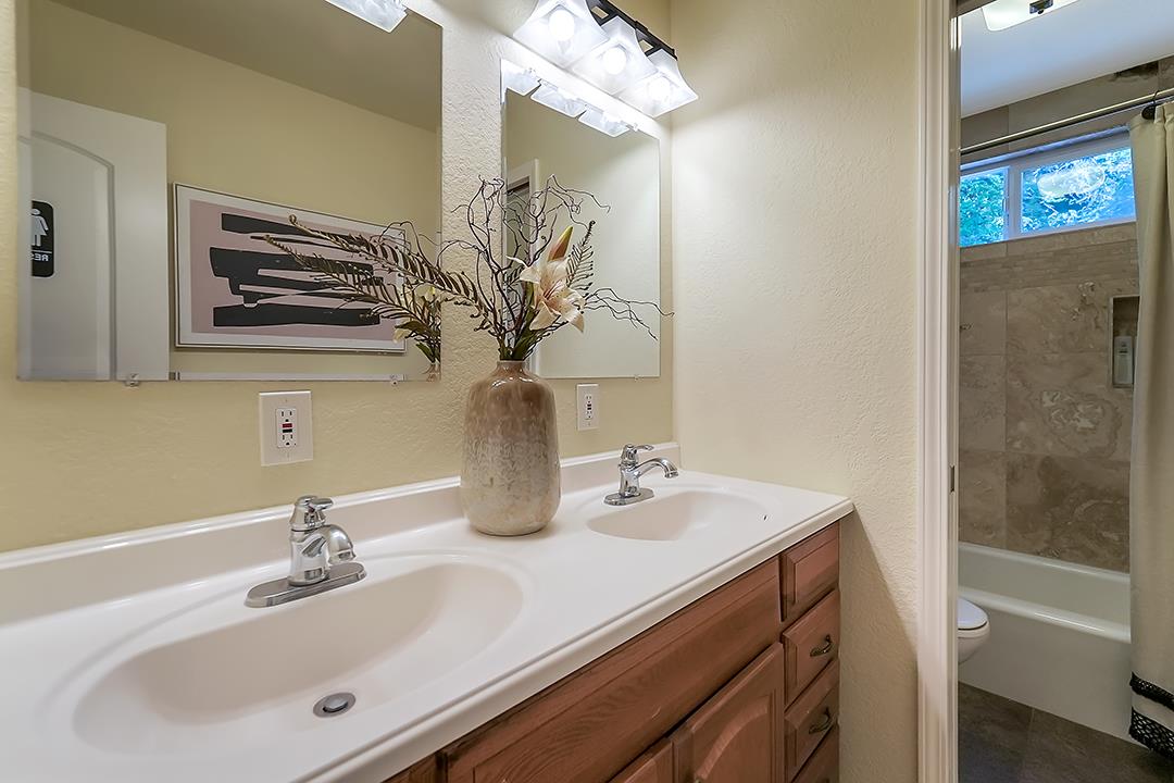14136 Long Ridge Road Los Gatos, CA 95033 - Photo 21 of 75 a bathroom with a sink a vanity and a mirror