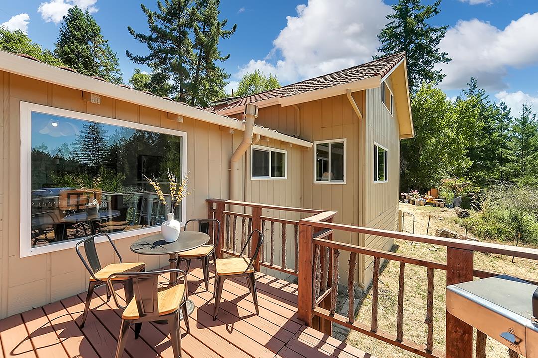14136 Long Ridge Road Los Gatos, CA 95033 - Photo 43 of 75 a view of a patio with table and chairs with wooden floor and fence