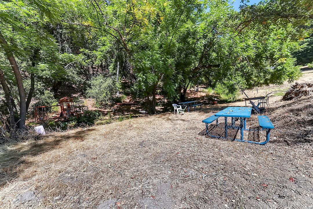 14136 Long Ridge Road Los Gatos, CA 95033 - Photo 55 of 75 a view of backyard with table and chairs and potted plants