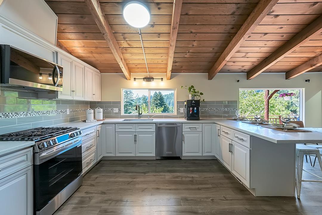 14136 Long Ridge Road Los Gatos, CA 95033 - Photo 9 of 75 a kitchen with stainless steel appliances granite countertop a stove a sink and a microwave