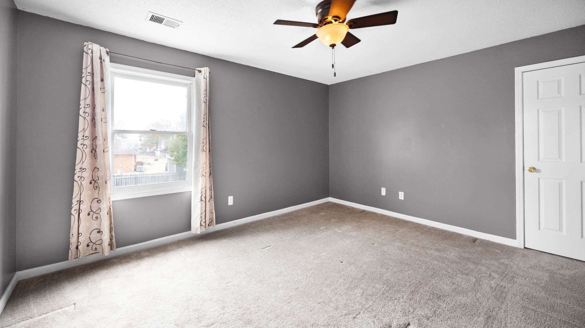 1105 Winrose Drive Collierville, TN 38017 - Photo 24 of 37 an empty room with a window and a fan
