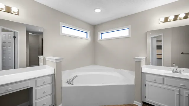 a bathroom with a sink a light fixture a vanity and a mirror