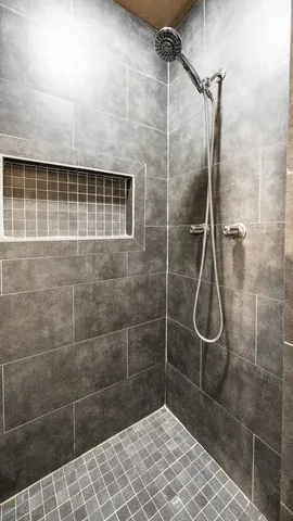 a bathroom with a tub sink and mirror