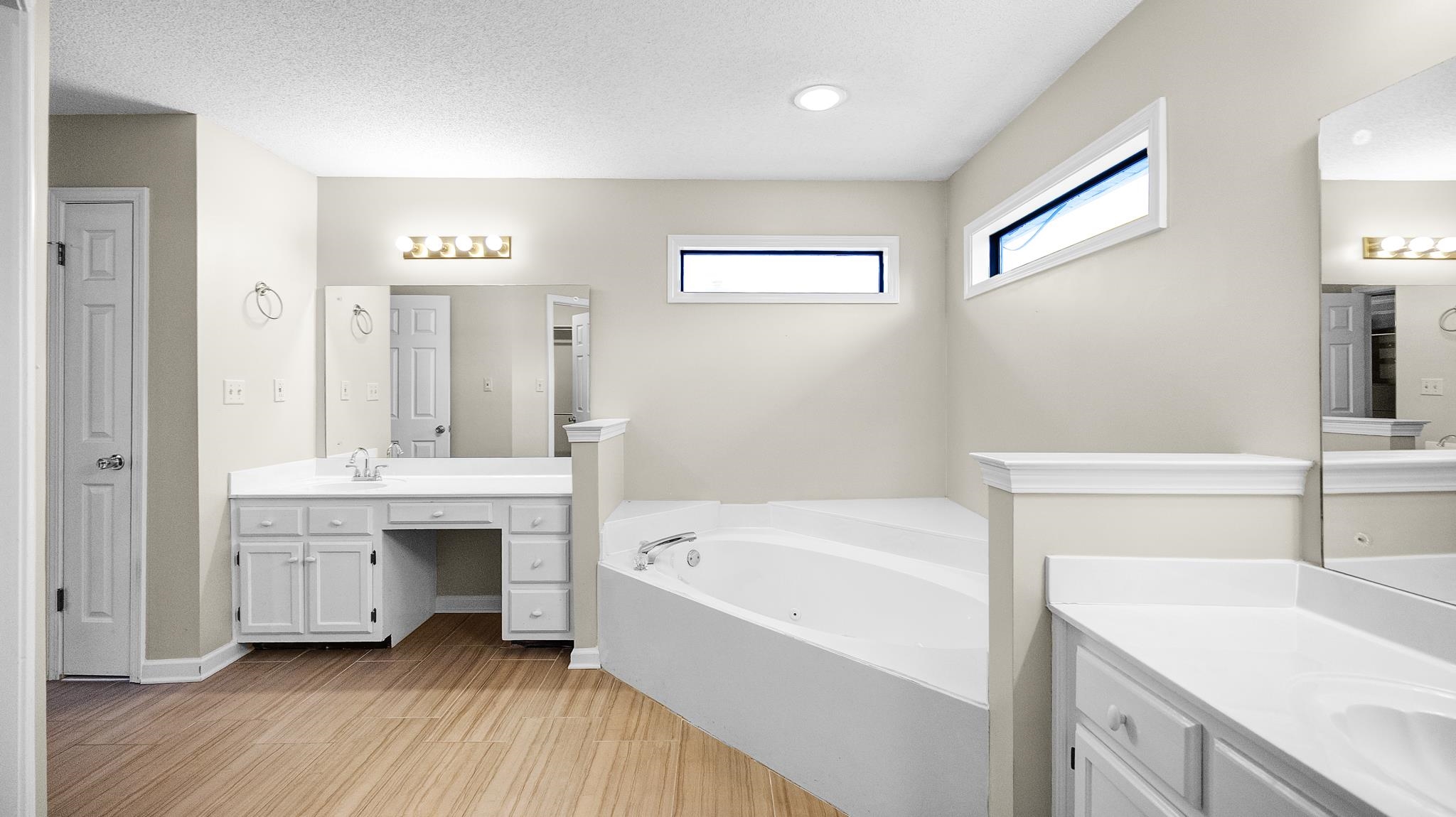 1105 Winrose Drive Collierville, TN 38017 - Photo 32 of 37 a bathroom with a tub sink and mirror