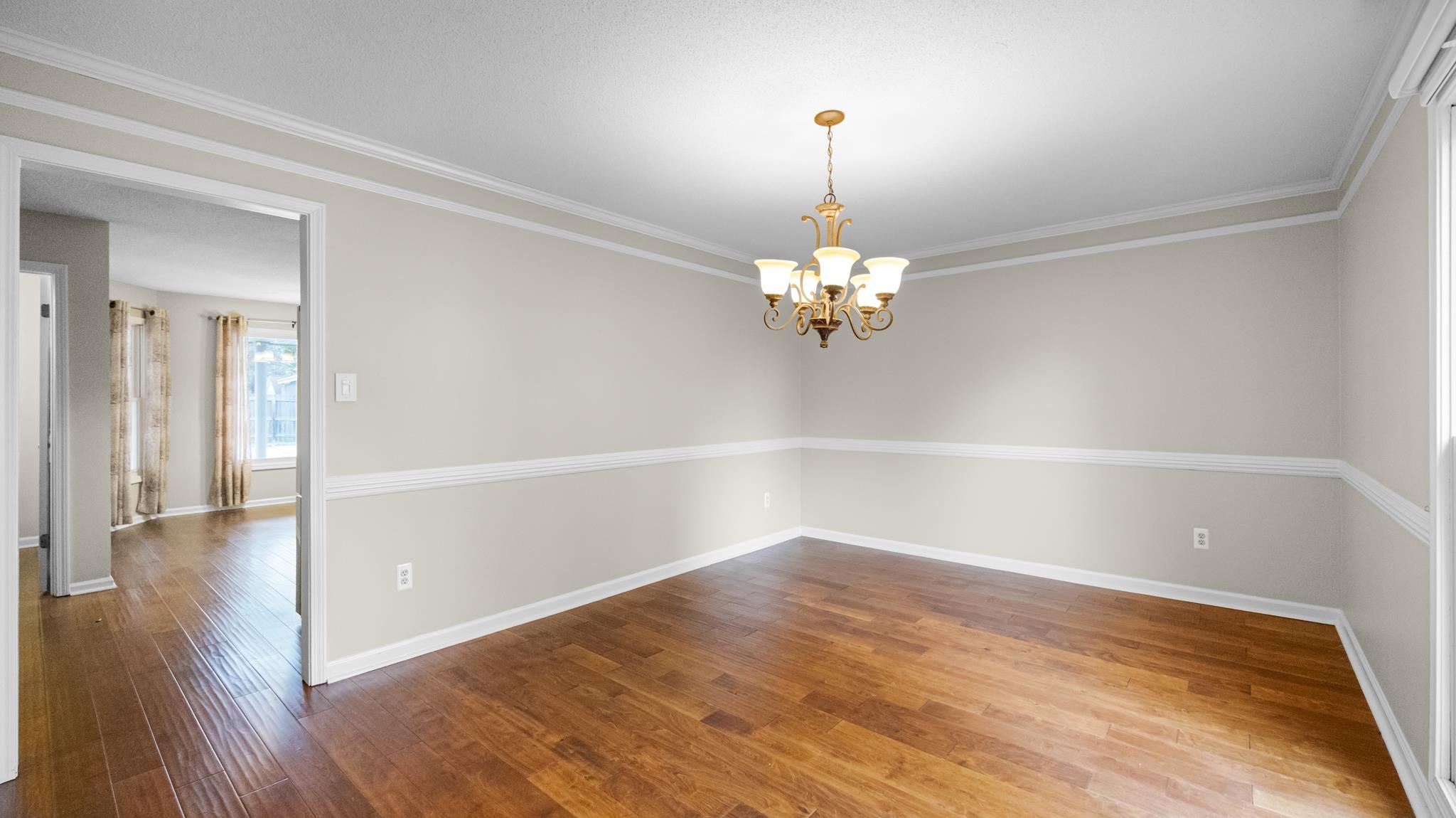 1105 Winrose Drive Collierville, TN 38017 - Photo 5 of 37 a view of an empty room with wooden floor and a window