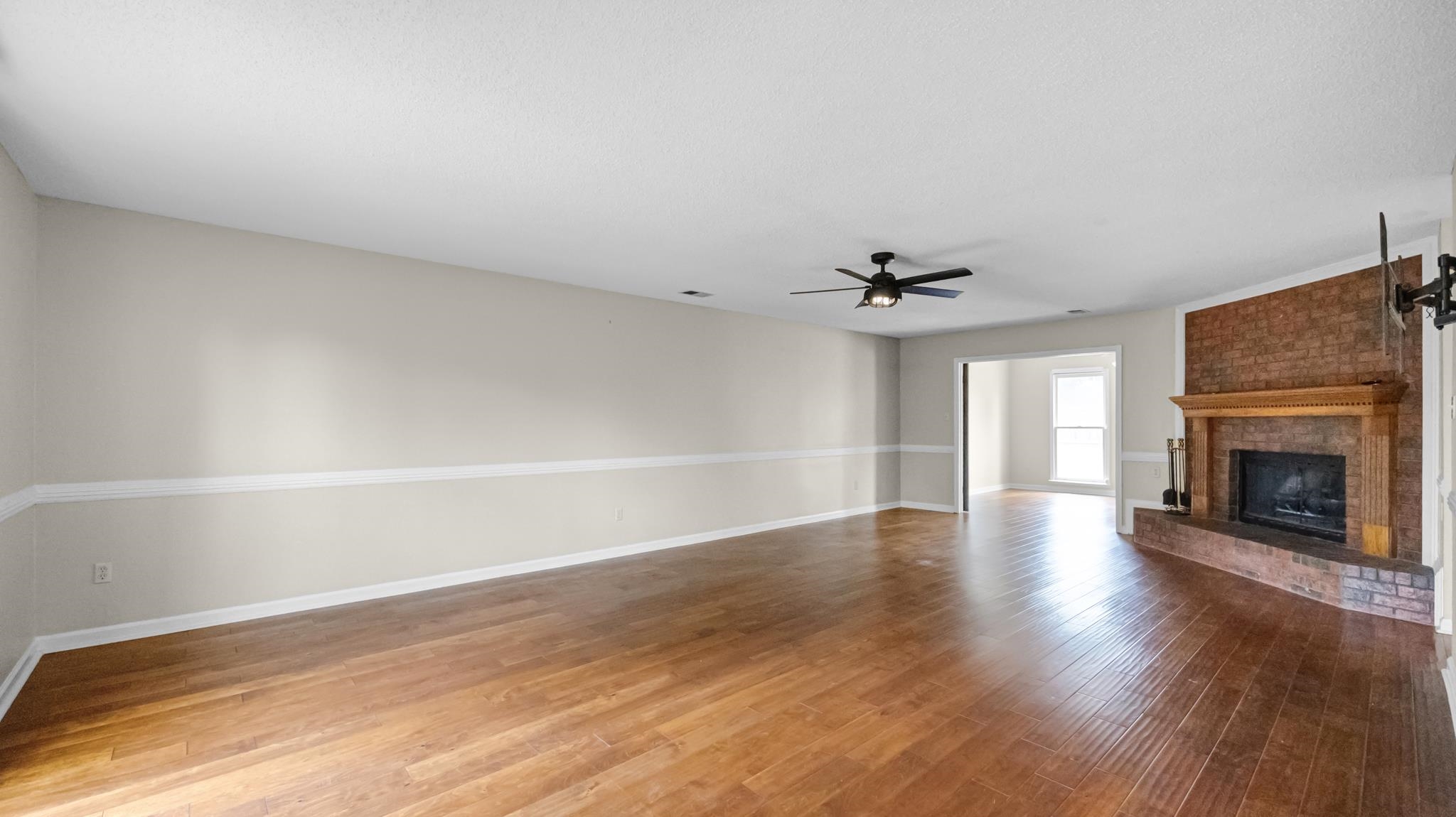 1105 Winrose Drive Collierville, TN 38017 - Photo 6 of 37 wooden floor in an empty room with a window
