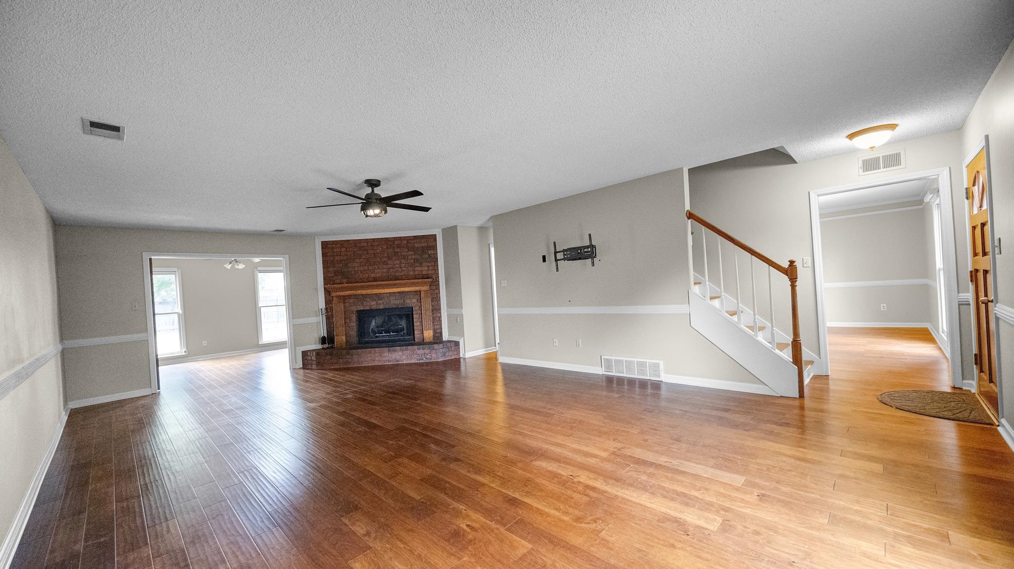 1105 Winrose Drive Collierville, TN 38017 - Photo 7 of 37 a view of an empty room with wooden floor fireplace and windows